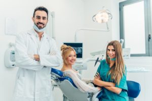 Dentist and hygienist treating a patient.